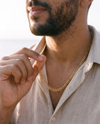 Man adjusting the Marco Maveri Franco Link Chain Necklace, close-up, Gold
