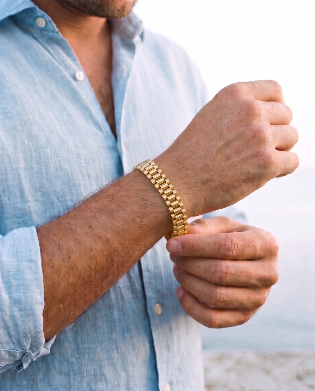 Man adjusting the Marco Maveri Geometric Link Bracelet in Titanium Steel, close-up, Gold