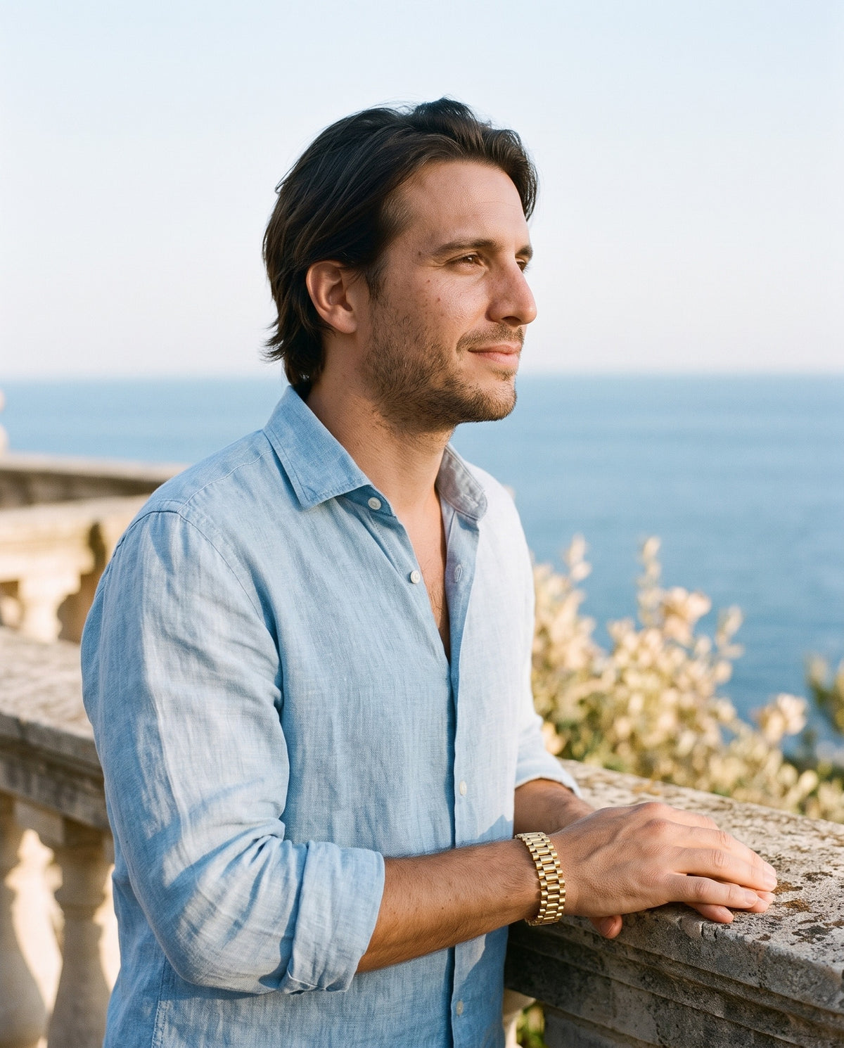 Man wearing the Marco Maveri Geometric Link Bracelet in Titanium Steel by the sea, Gold