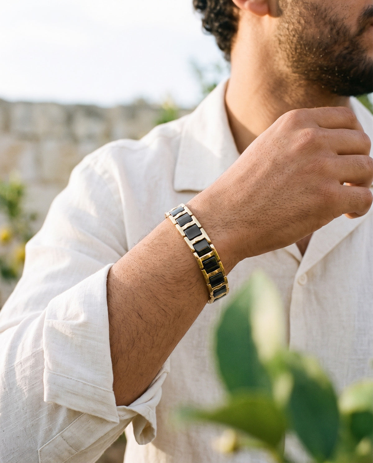 Marco Maveri Geometric Link Bracelet with Ceramic Inlay worn with a linen shirt, close-up, Black / Gold