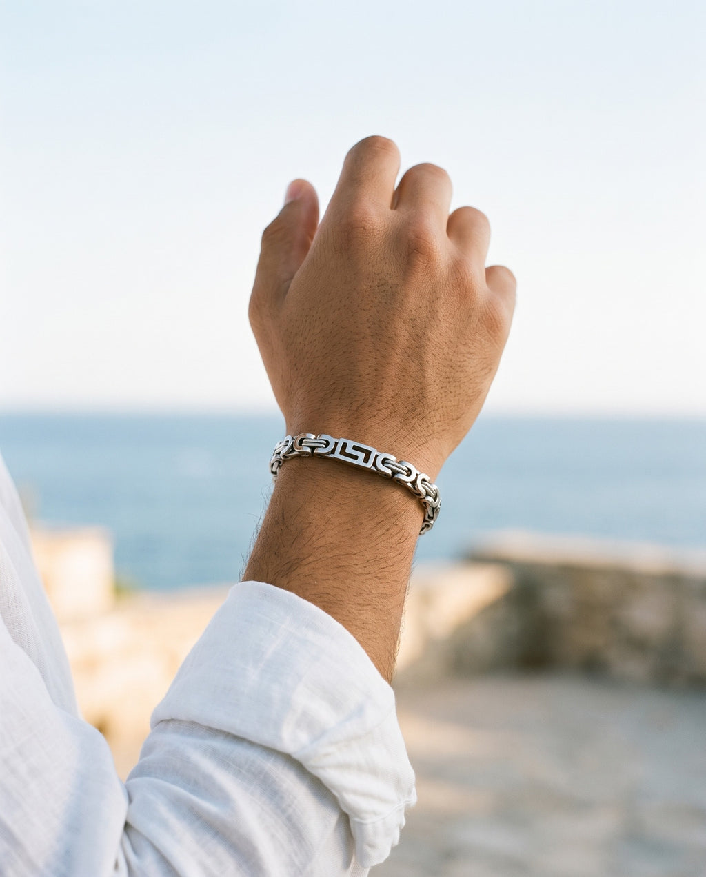 Marco Maveri Geometric Link Byzantine Bracelet worn with a linen shirt, close-up, Silver