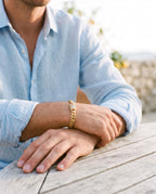 Marco Maveri Gold-Tone Cuban Link Bracelet worn with a linen shirt, close-up, Gold