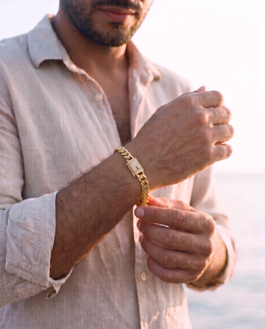 Man adjusting the Marco Maveri Gold-Tone Cuban Link Bracelet, close-up, Gold