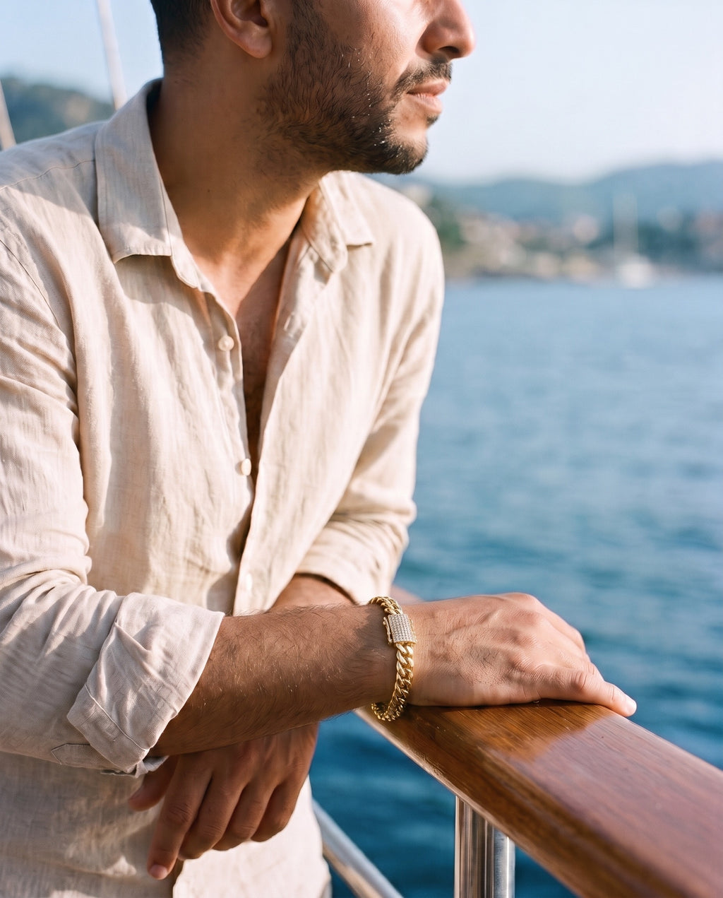 Man wearing the Marco Maveri Gold-Tone Cuban Link Bracelet by the sea, Gold