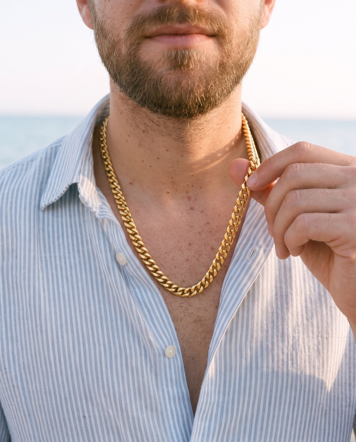 Man adjusting the Marco Maveri Gold-Tone Cuban Link Chain, close-up, Gold
