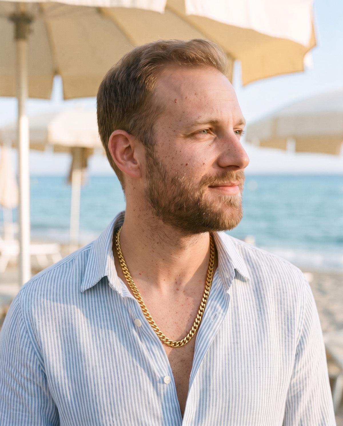 Man wearing the Marco Maveri Gold-Tone Cuban Link Chain by the sea, Gold
