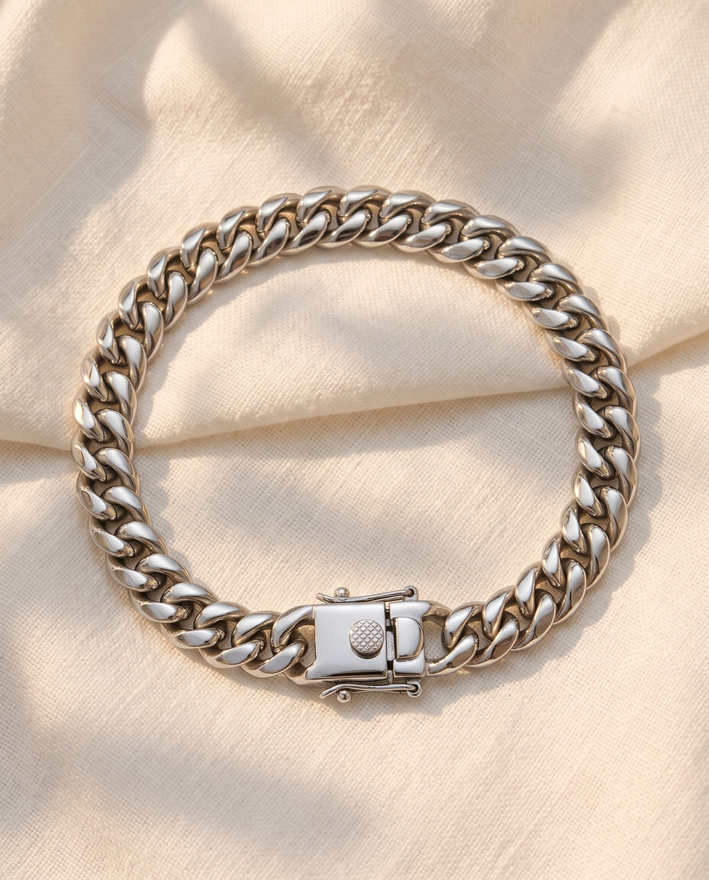 Marco Maveri Heavy Curb Chain Bracelet laid on cream linen, Silver