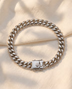 Marco Maveri Heavy Curb Chain Bracelet laid on cream linen, Silver