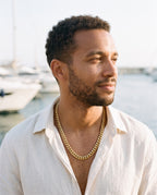 Man wearing the Marco Maveri Heavy Curb Chain Necklace by the sea, Gold