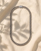 Marco Maveri Heavy Curb Chain Necklace laid on cream linen, Silver