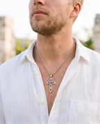 Marco Maveri Hollow Double Cross Pendant Necklace worn with a linen shirt, close-up, Silver