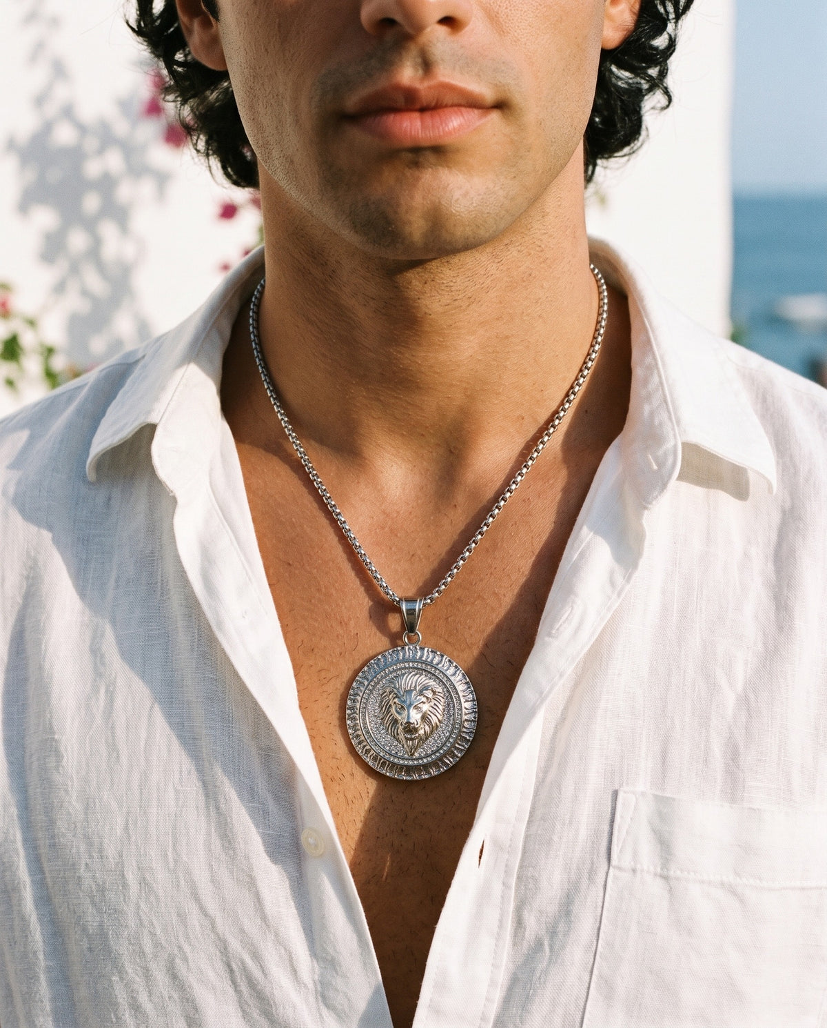 Marco Maveri Lion Head Medallion Pendant Necklace worn with a linen shirt, close-up, Silver