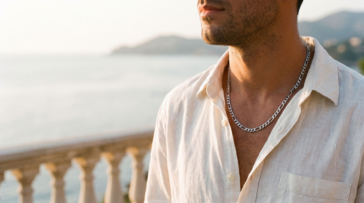3mm figaro chain worn with an open ivory linen shirt on a seaside terrace