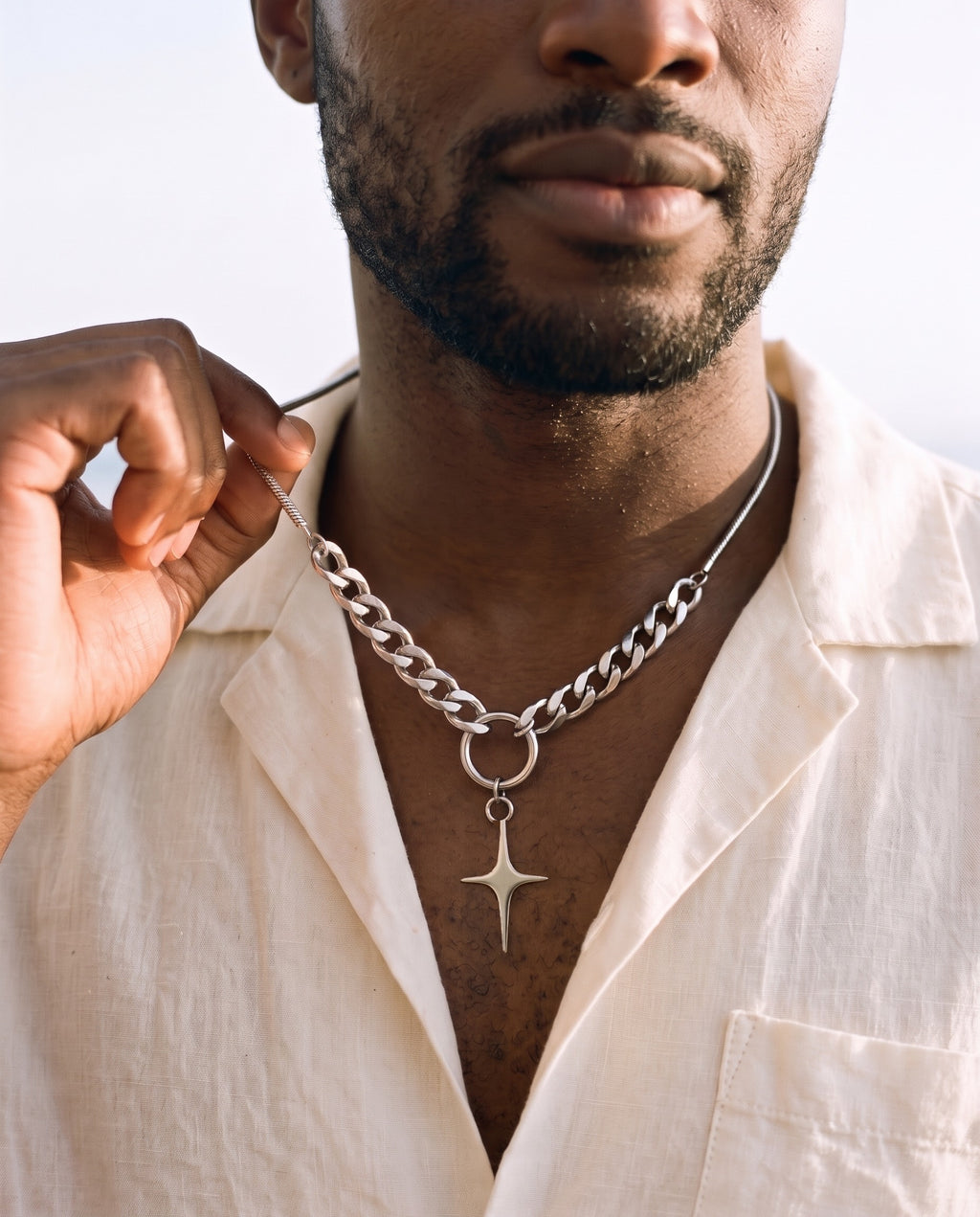 Man adjusting the Marco Maveri Mixed Chain with Four-Point Star Pendant, close-up, Silver