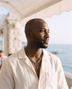 Man wearing the Marco Maveri Mixed Chain with Four-Point Star Pendant by the sea, Silver