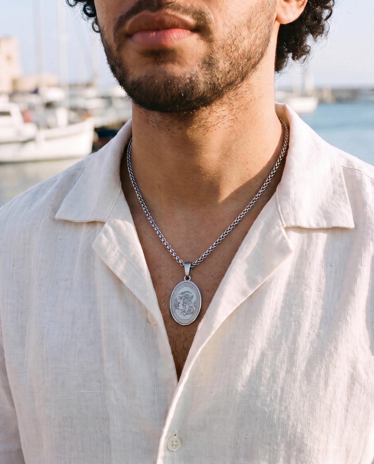 Marco Maveri Oval Medallion Pendant Necklace worn with a linen shirt, close-up, Silver