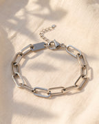 Marco Maveri Paperclip Link Bracelet laid on cream linen, Silver
