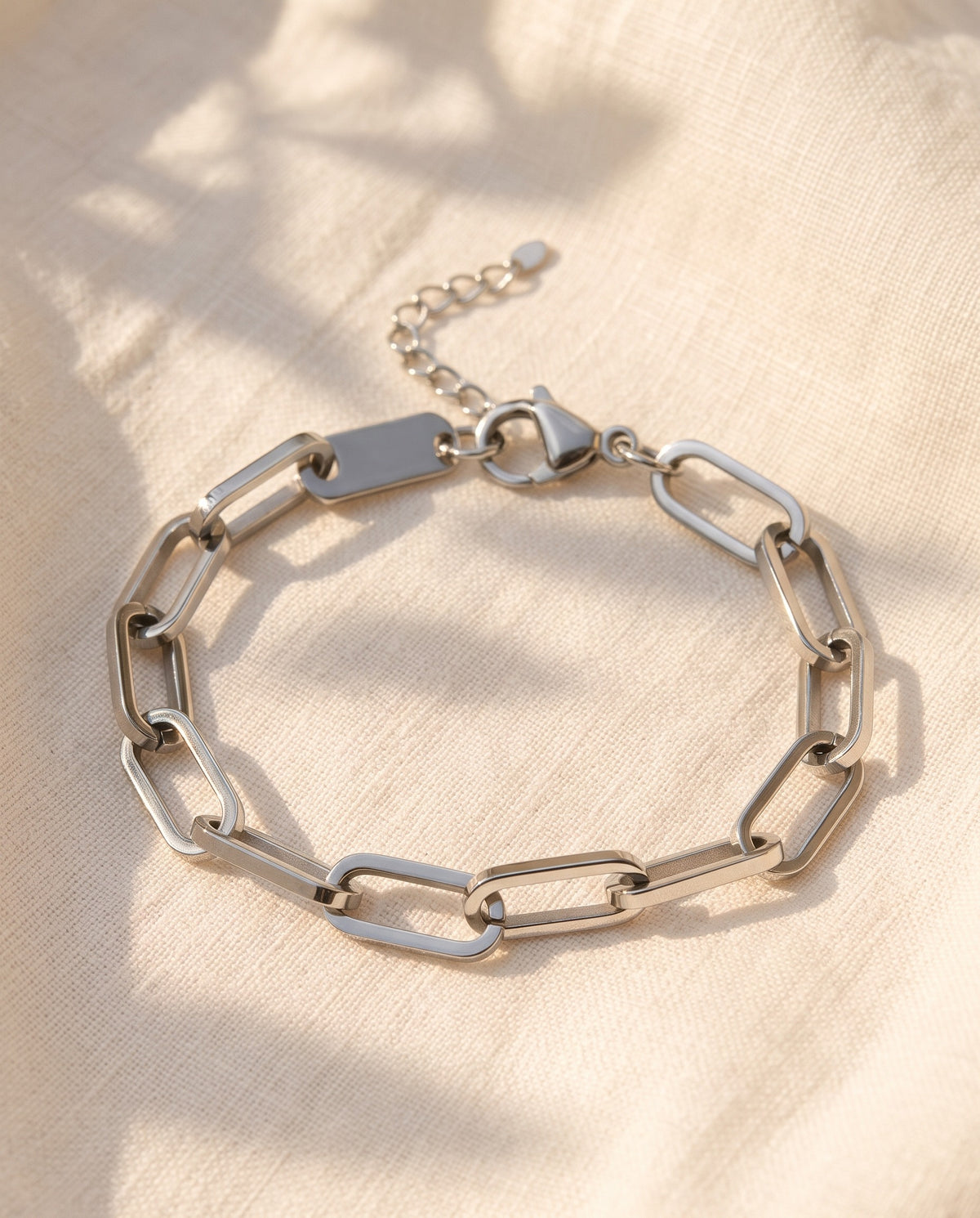 Marco Maveri Paperclip Link Bracelet laid on cream linen, Silver