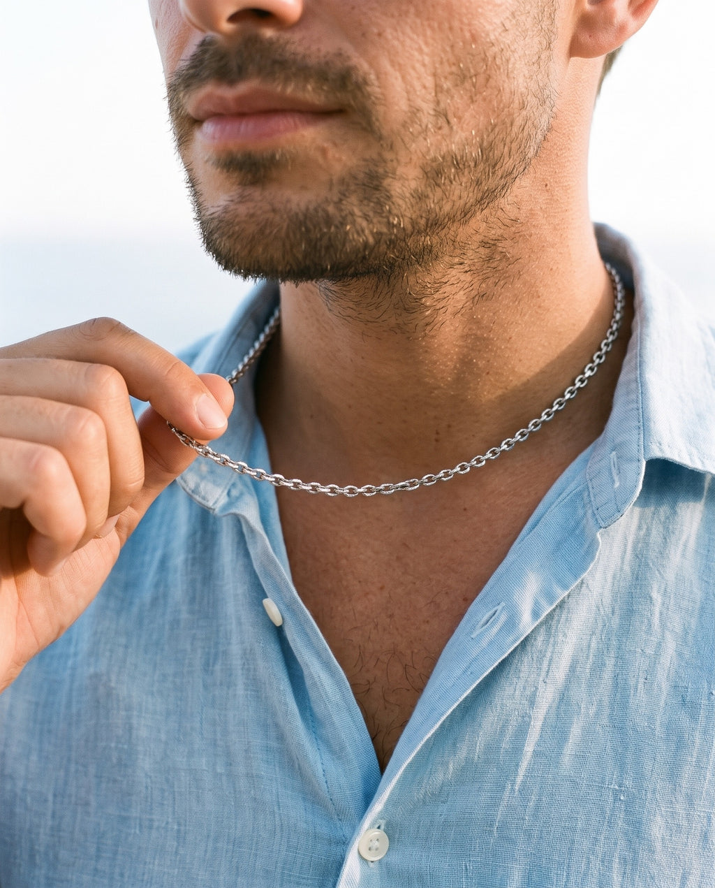 Man adjusting the Marco Maveri Polished Cable Link Chain Necklace, close-up, Silver