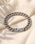 Marco Maveri Polished Cuban Link Bracelet laid on cream linen, Silver