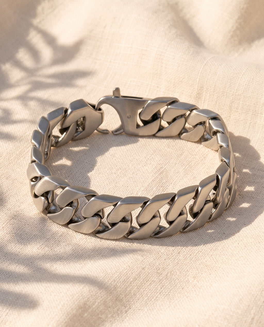 Marco Maveri Polished Curb Link Bracelet laid on cream linen, Silver