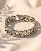 Marco Maveri Polished Curb Link Bracelet laid on cream linen, Silver