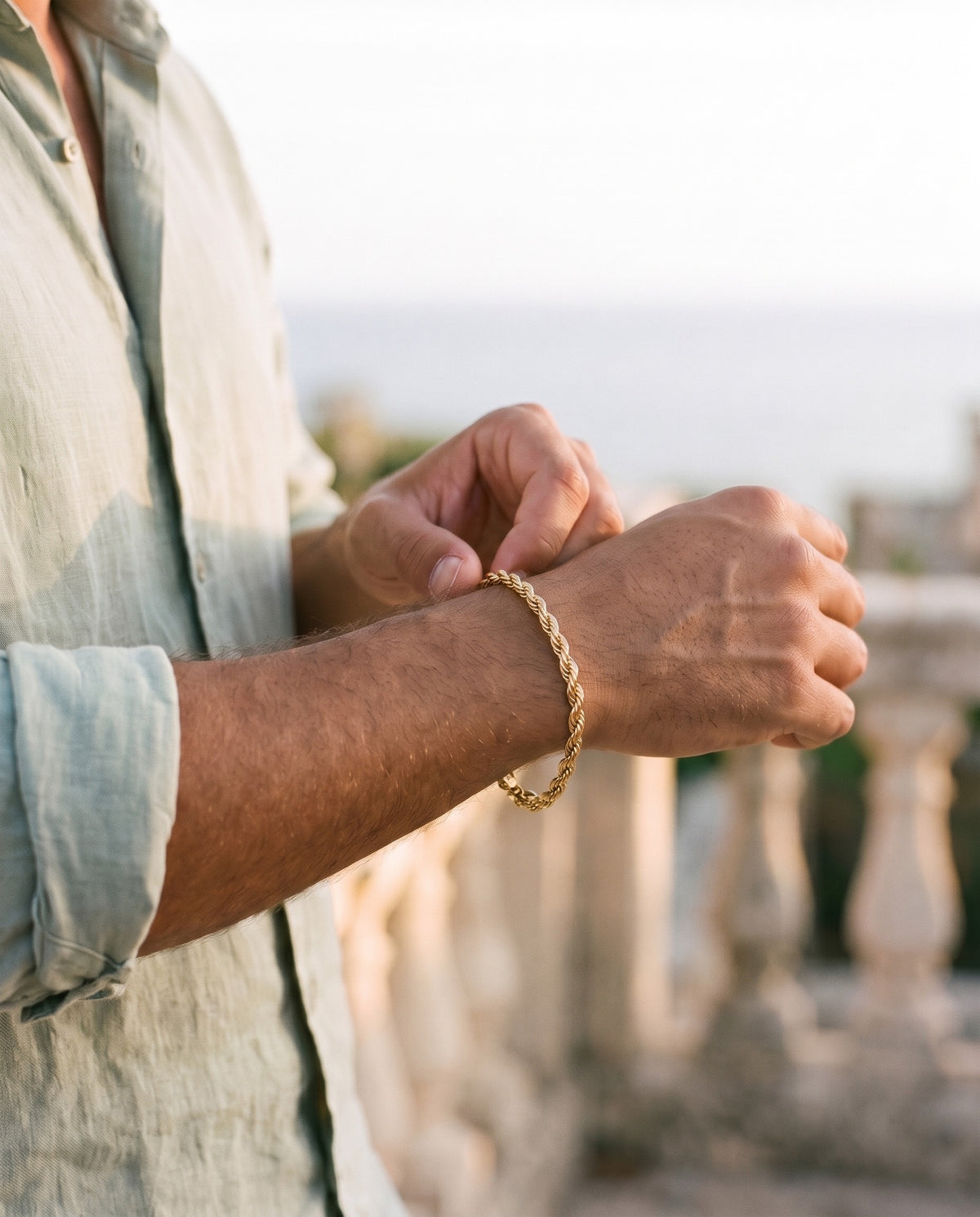 Man adjusting the Marco Maveri Rope Chain Bracelet in Stainless Steel, close-up, Gold