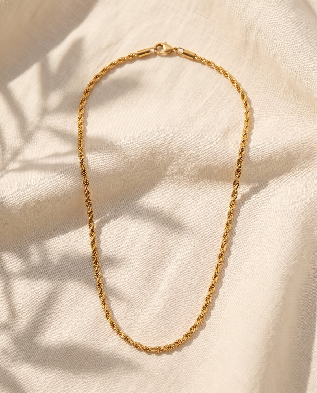 Marco Maveri Rope Chain in Gold-Tone Titanium Steel laid on cream linen, Gold