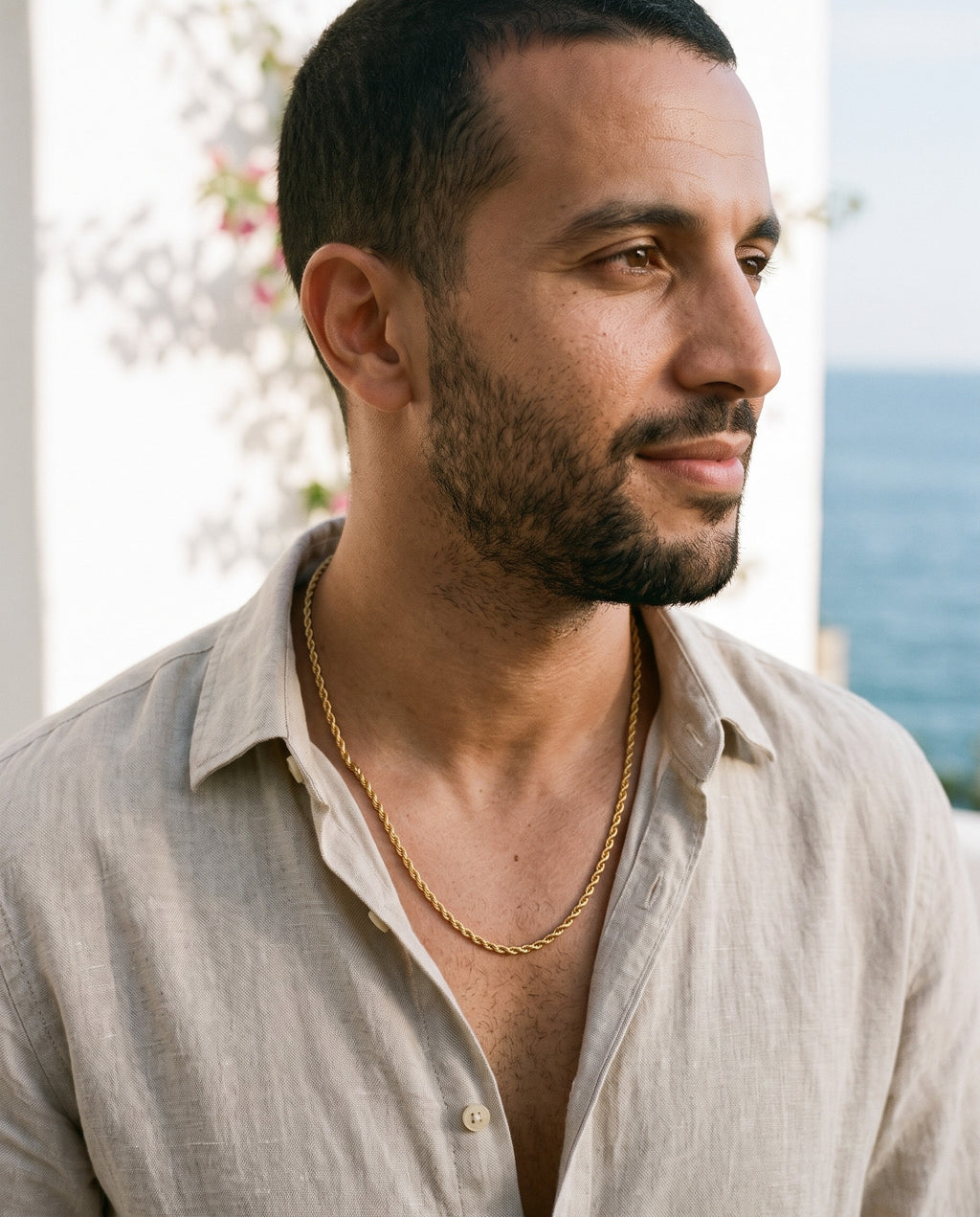 Man wearing the Marco Maveri Rope Chain in Gold-Tone Titanium Steel by the sea, Gold