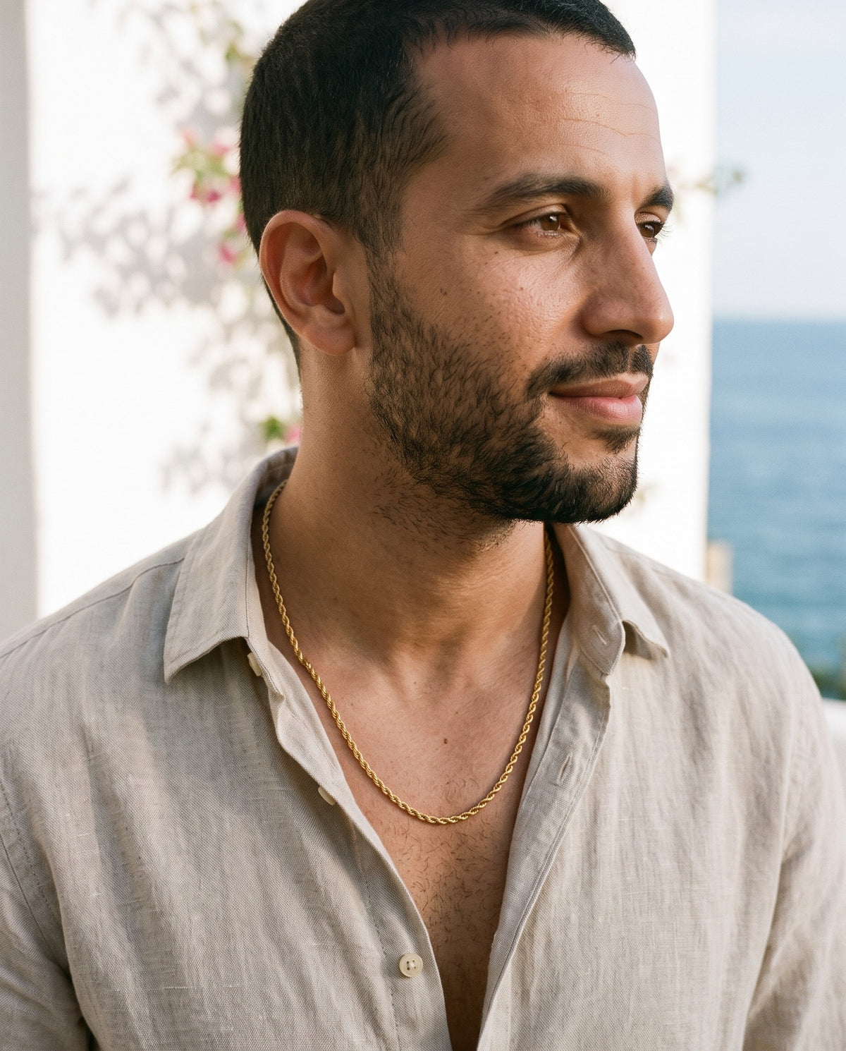 Man wearing the Marco Maveri Rope Chain in Gold-Tone Titanium Steel by the sea, Gold