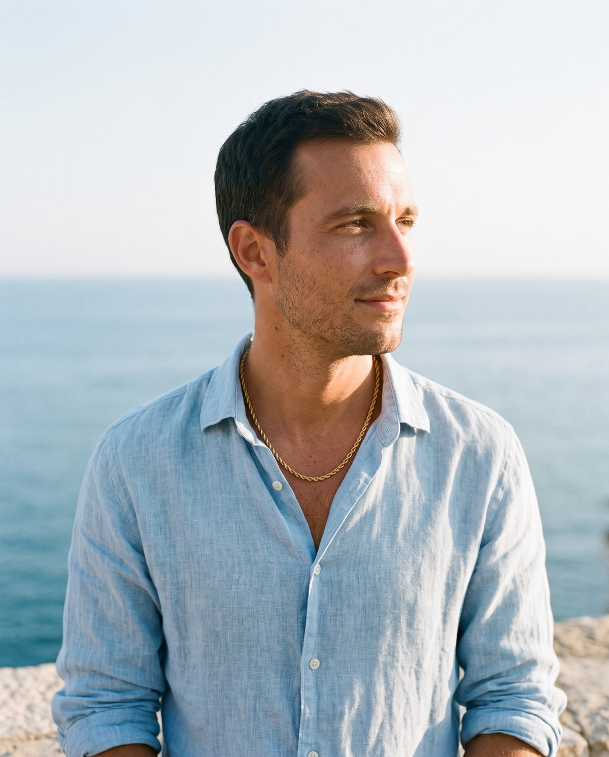 Man wearing the Marco Maveri Rope Chain Necklace in Stainless Steel by the sea, Gold