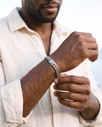 Man adjusting the Marco Maveri Silver Cuban Link Bracelet, close-up, Silver