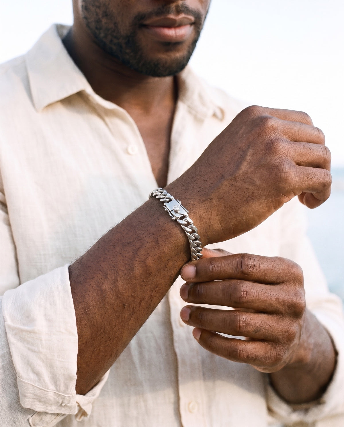Man adjusting the Marco Maveri Silver Cuban Link Bracelet, close-up, Silver