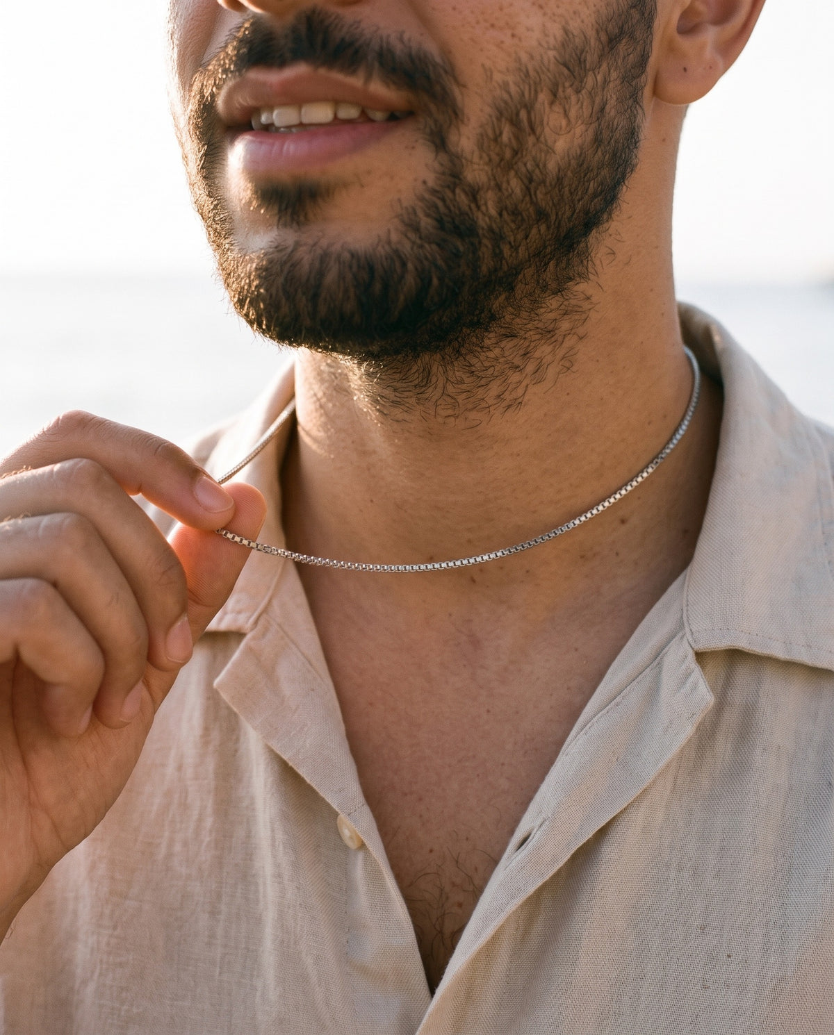 Man adjusting the Marco Maveri Stainless Steel Box Chain Necklace, close-up, Silver