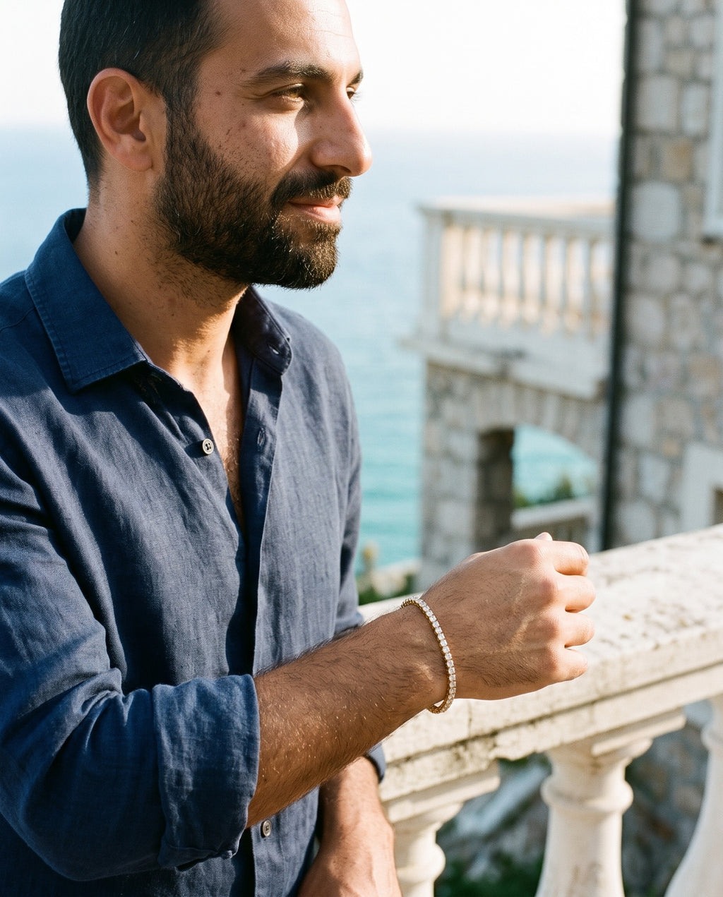 Man wearing the Marco Maveri Tennis Bracelet with Cubic Zirconia by the sea, Gold