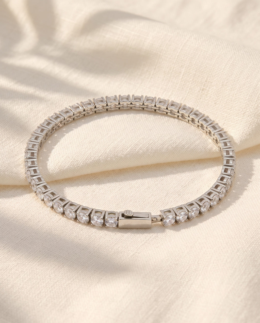 Marco Maveri Tennis Bracelet with Cubic Zirconia laid on cream linen, Silver