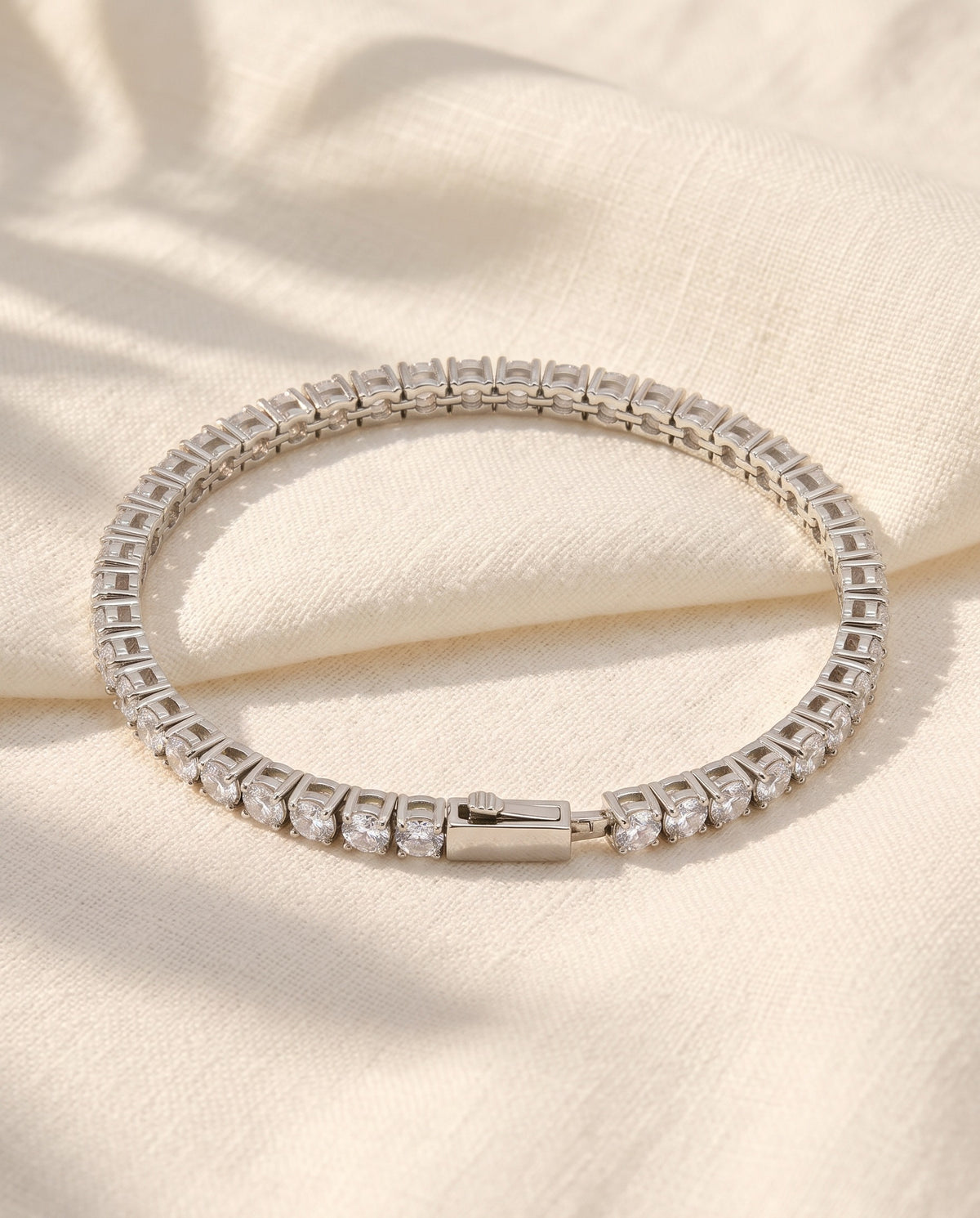 Marco Maveri Tennis Bracelet with Cubic Zirconia laid on cream linen, Silver