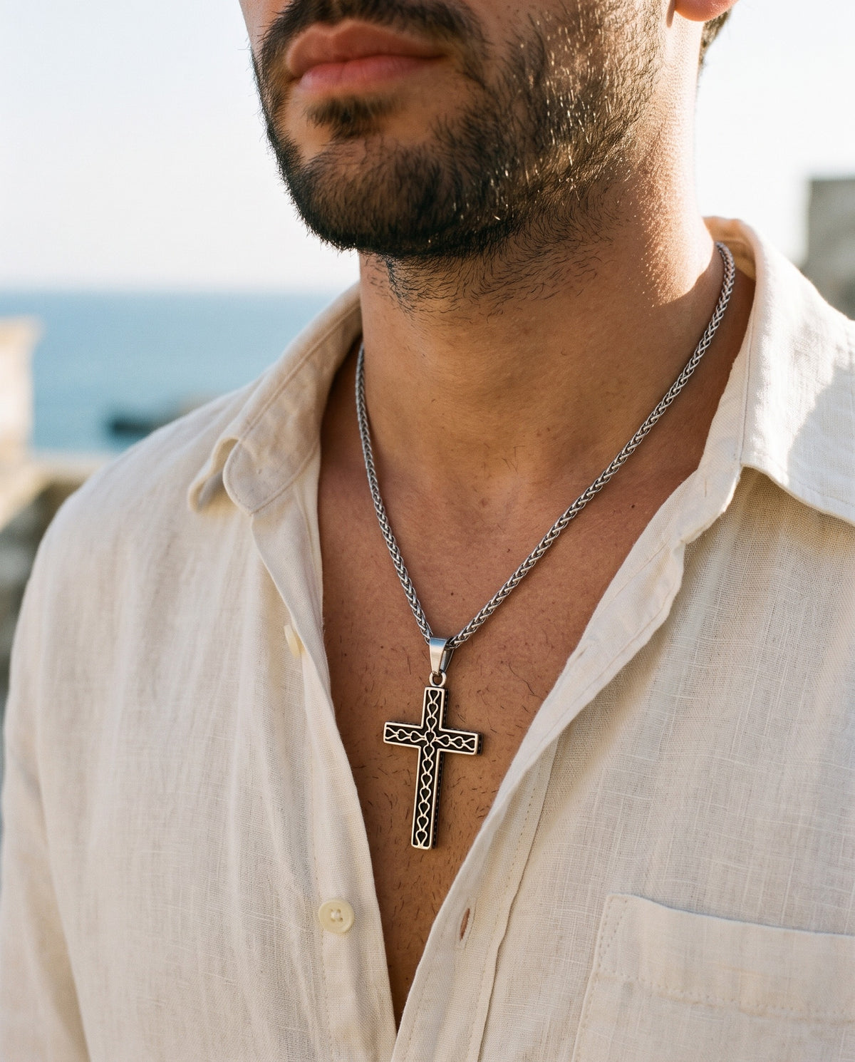 Marco Maveri Textured Cross Pendant Necklace worn with a linen shirt, close-up, Silver