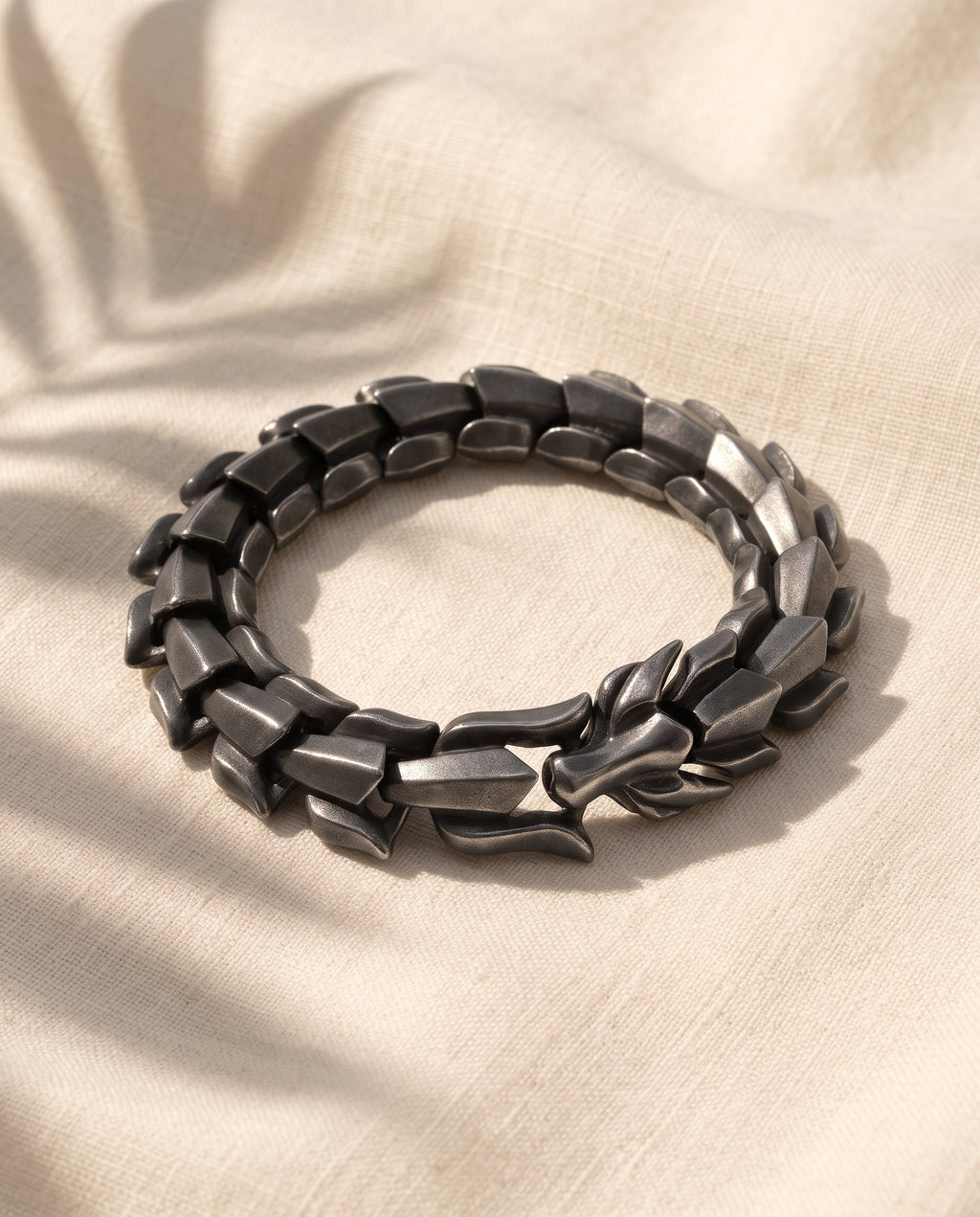 Marco Maveri Titanium Steel Keel Link Bracelet laid on cream linen, Black