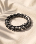 Marco Maveri Titanium Steel Keel Link Bracelet laid on cream linen, Black