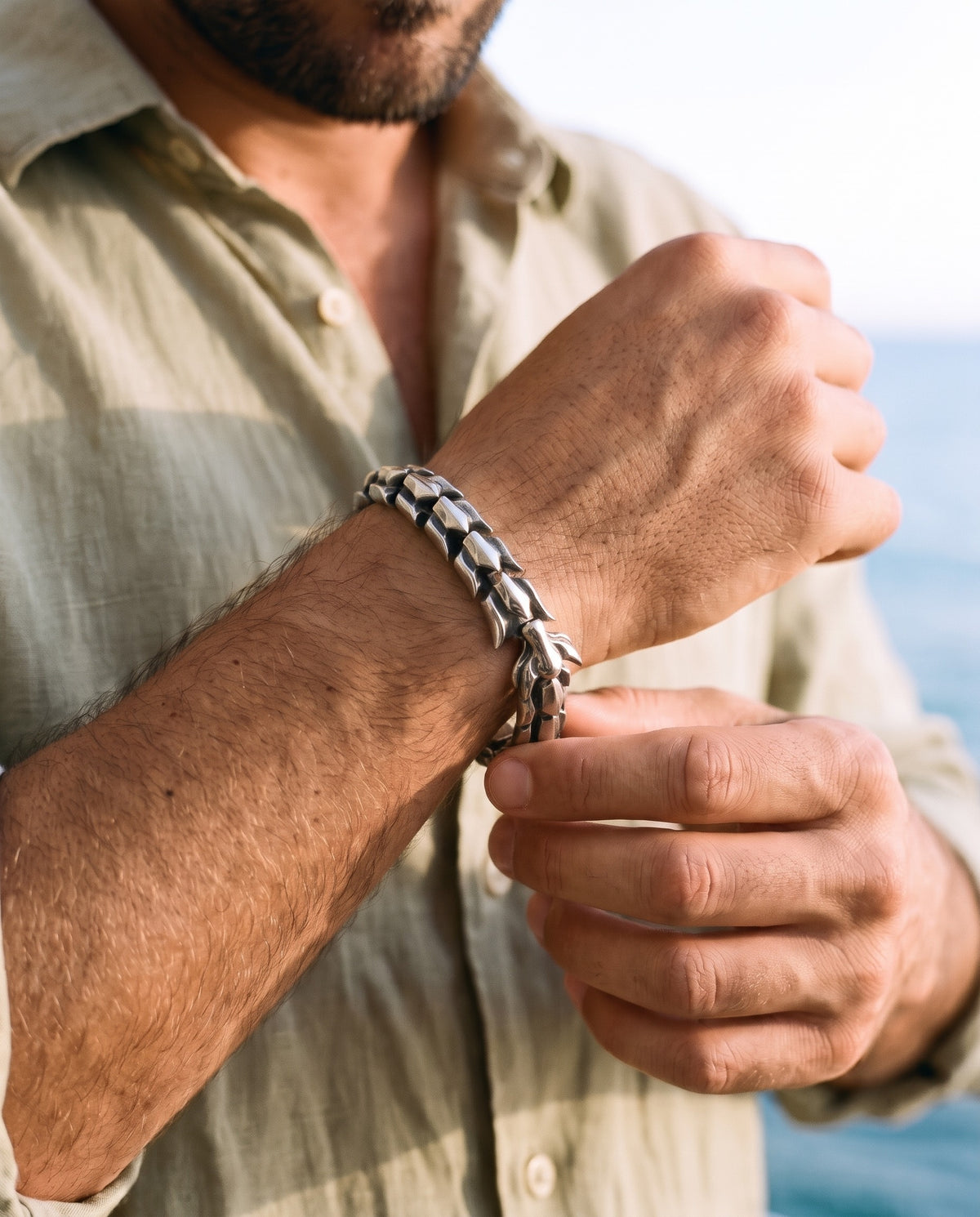 Man adjusting the Marco Maveri Titanium Steel Keel Link Bracelet, close-up, Silver