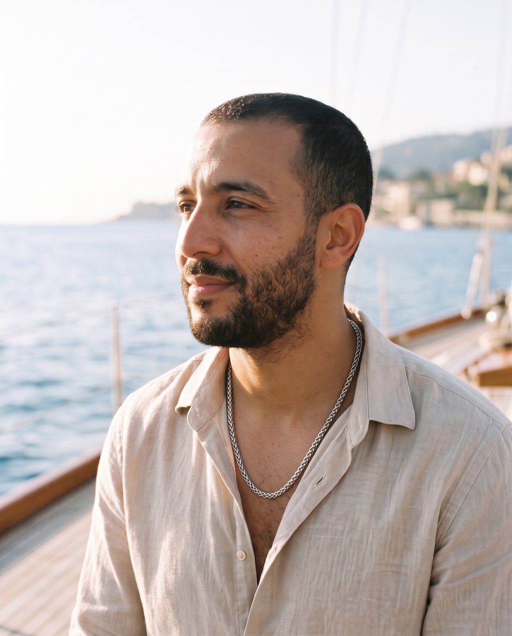 Man wearing the Marco Maveri Titanium Steel Wheat Chain by the sea, Silver