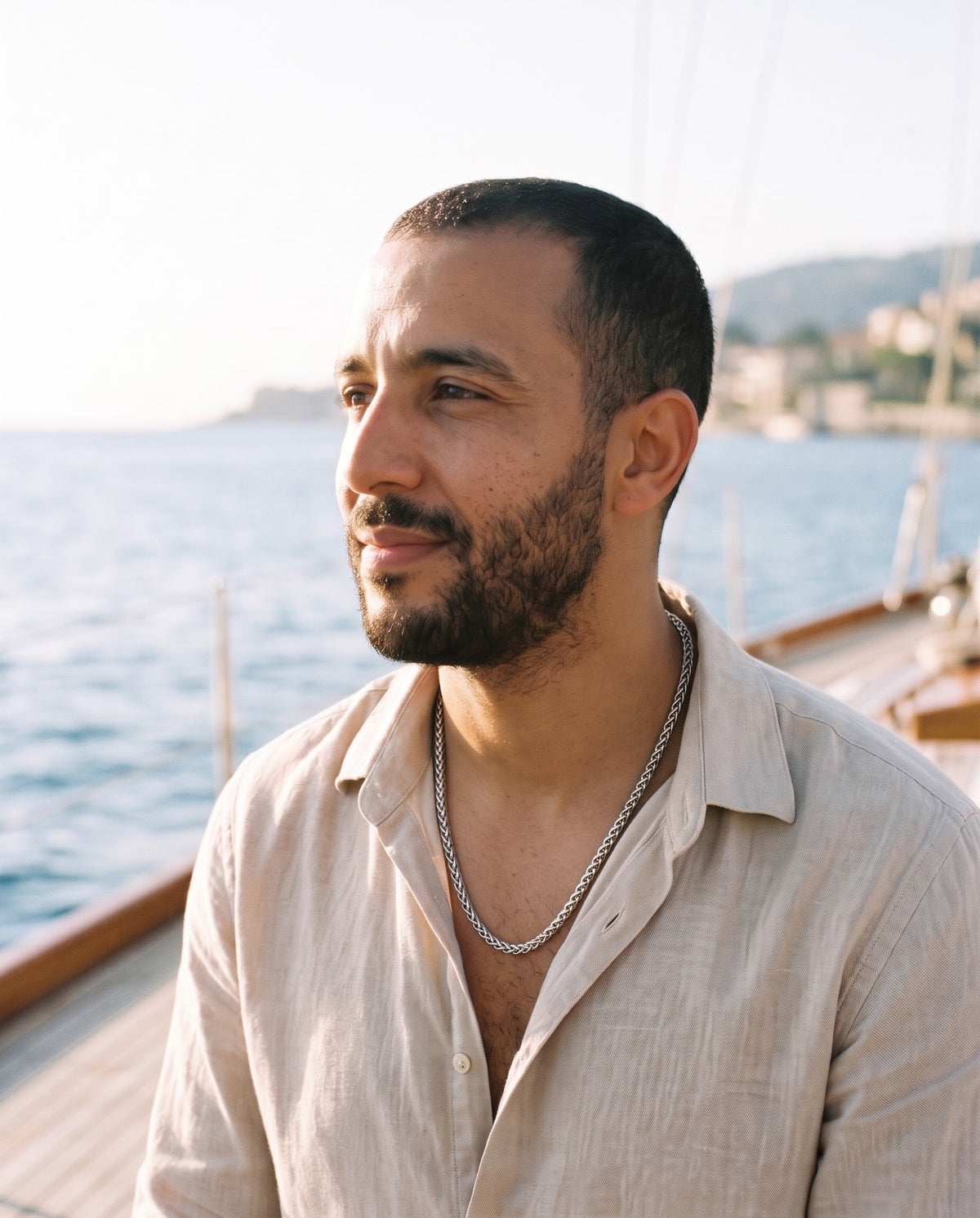 Man wearing the Marco Maveri Titanium Steel Wheat Chain by the sea, Silver