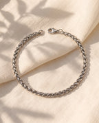 Marco Maveri Wheat Link Chain Bracelet laid on cream linen, Silver