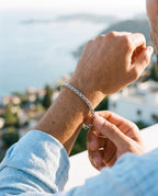 Man adjusting the Marco Maveri Wheat Link Chain Bracelet, close-up, Silver