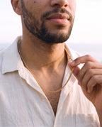 Man adjusting the Marco Maveri Wheat Link Chain in Titanium Steel, close-up, Gold