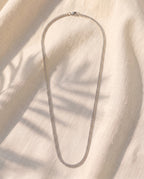 Marco Maveri Wheat Link Chain in Titanium Steel laid on cream linen, Silver