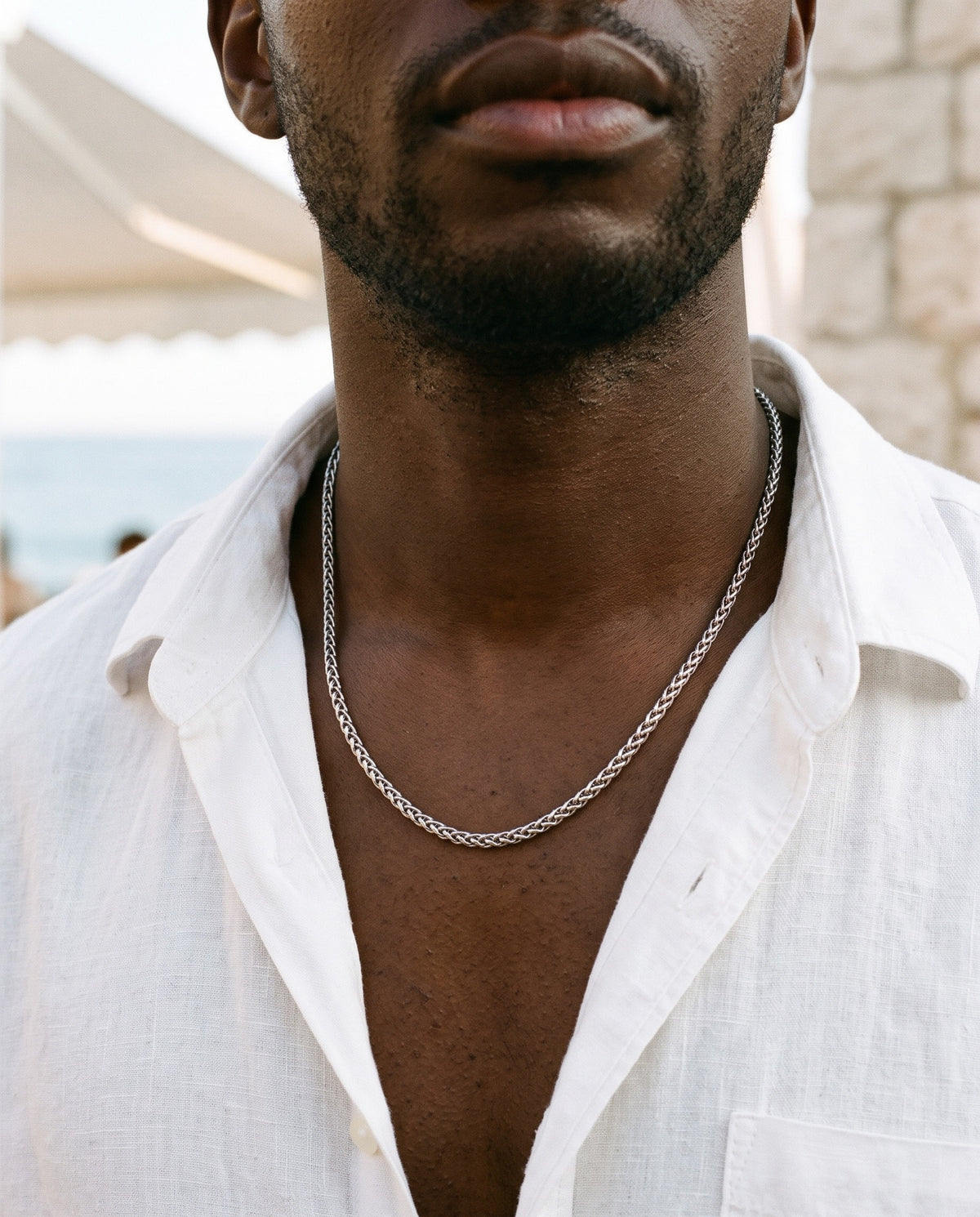Marco Maveri Wheat Link Chain in Titanium Steel worn with a linen shirt, close-up, Silver
