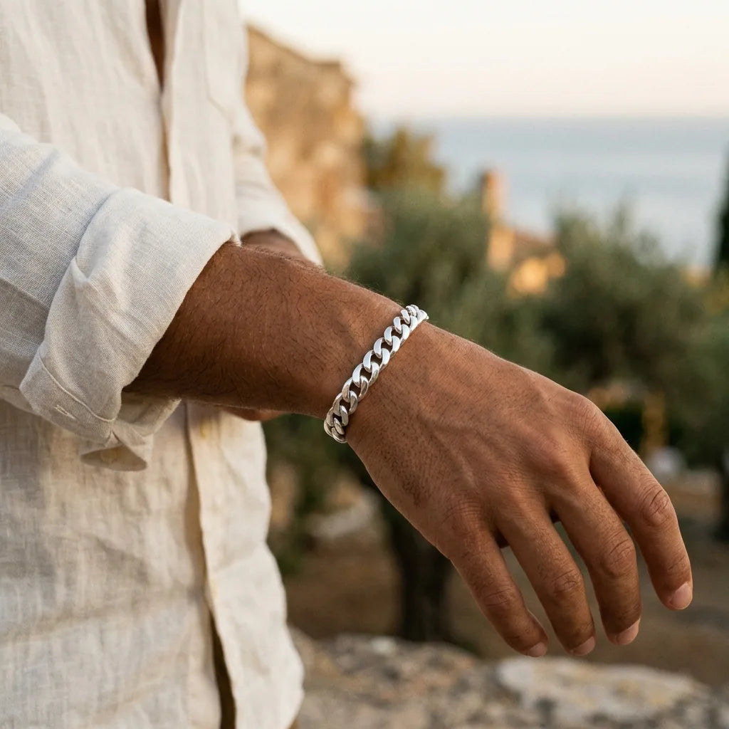 Silver curb-link bracelet worn on the wrist — honest materials, serious weight
